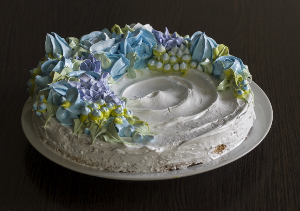 a white cake with blue and yellow flowers on it