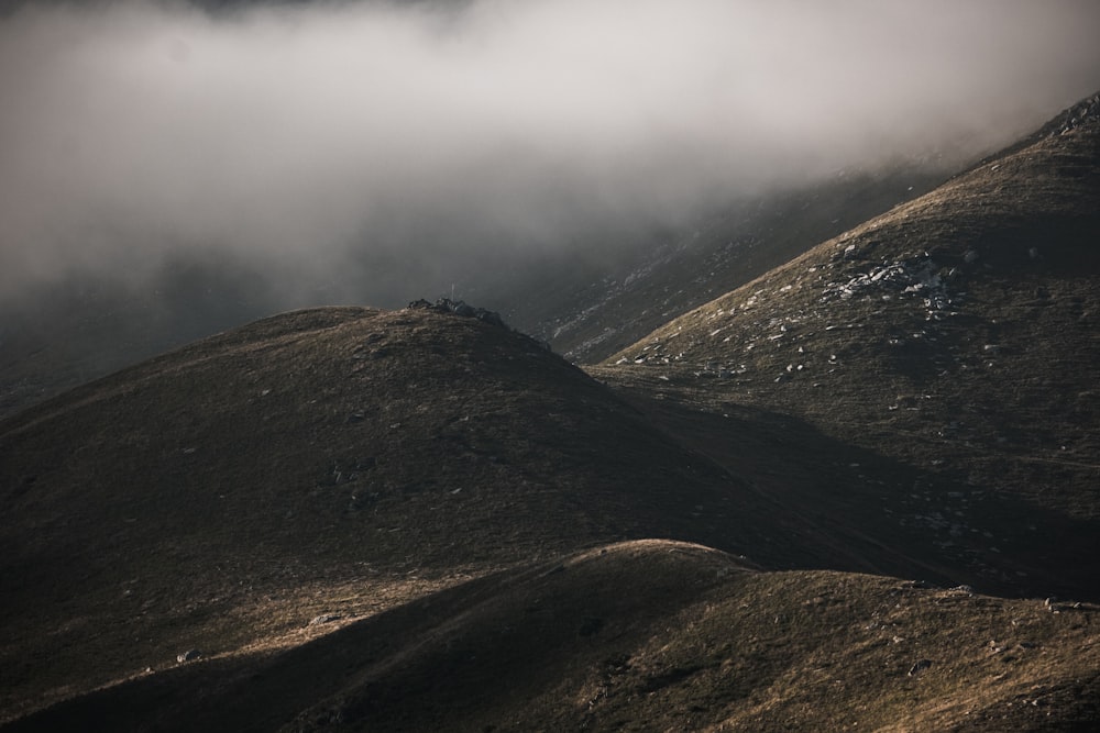 a view of a mountain with low lying clouds