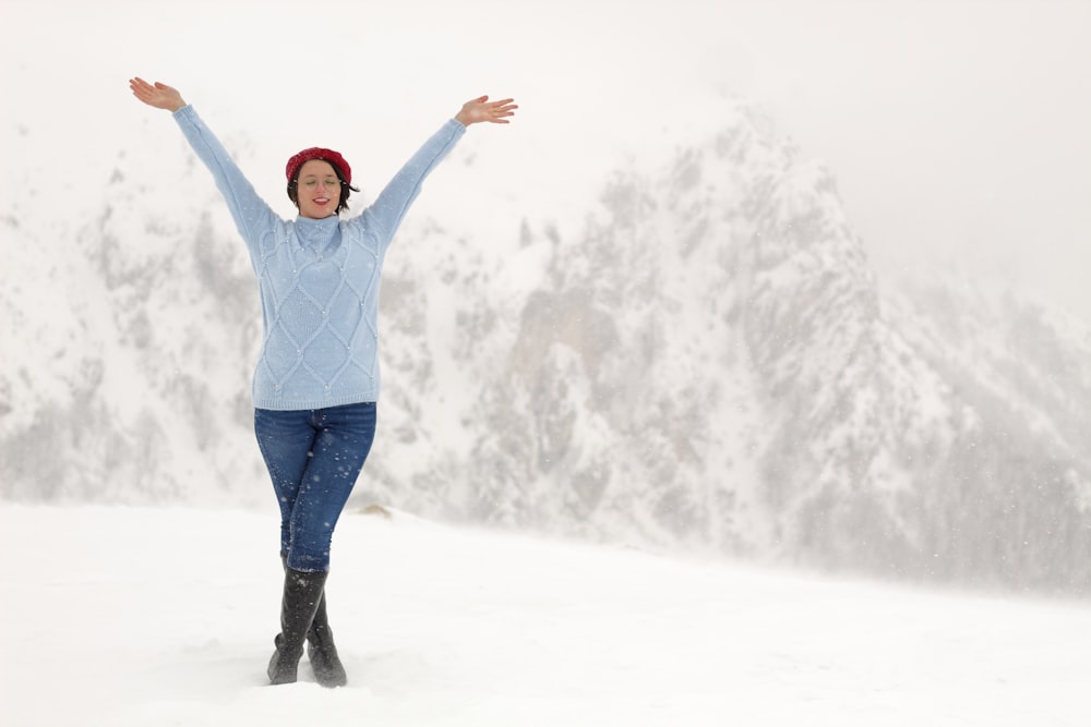 a woman with her arms outstretched in the snow