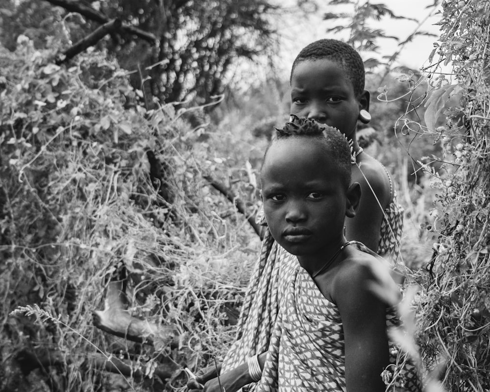 a couple of kids standing next to each other