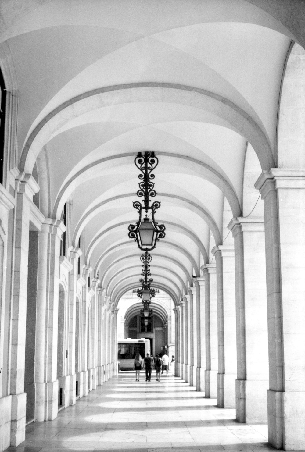 a black and white photo of a long hallway