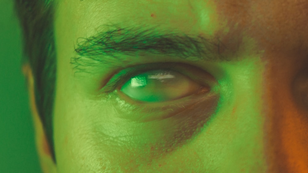 a close up of a man's green eye
