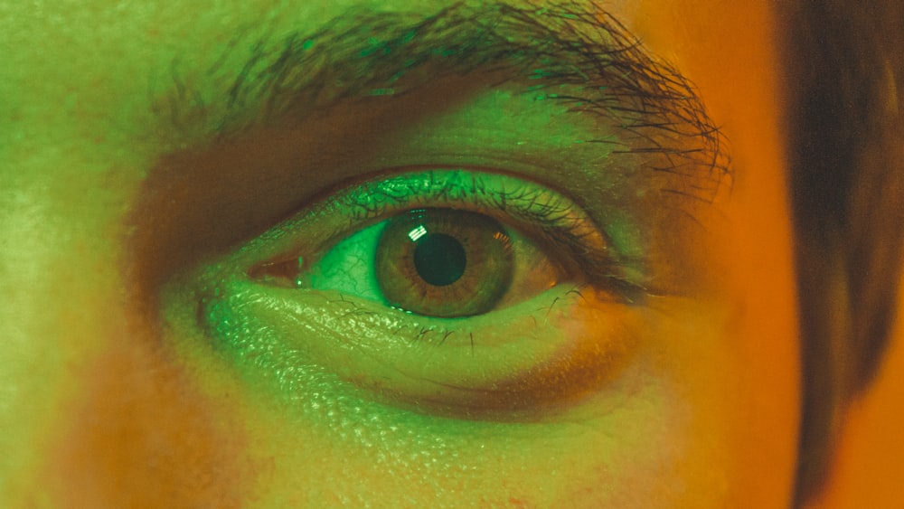 a close up of a person's green eye