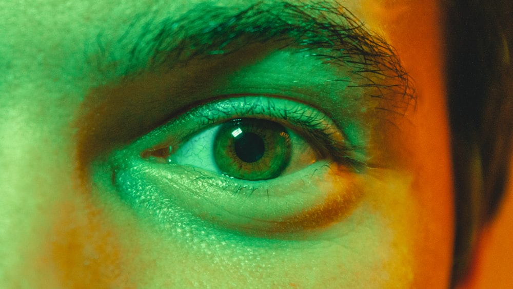 a close up of a person's green eye