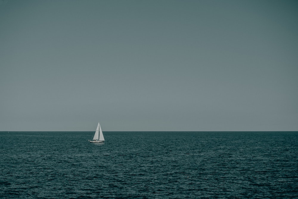 a sailboat in the middle of the ocean