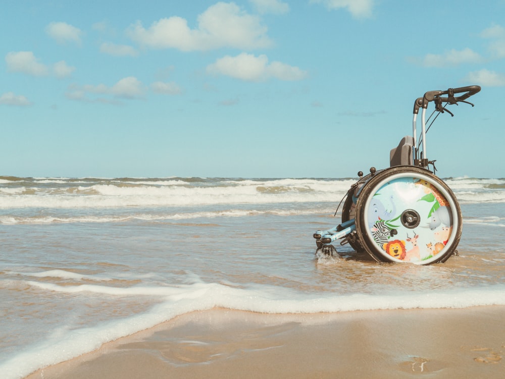 a beach scene with a bicycle in the water