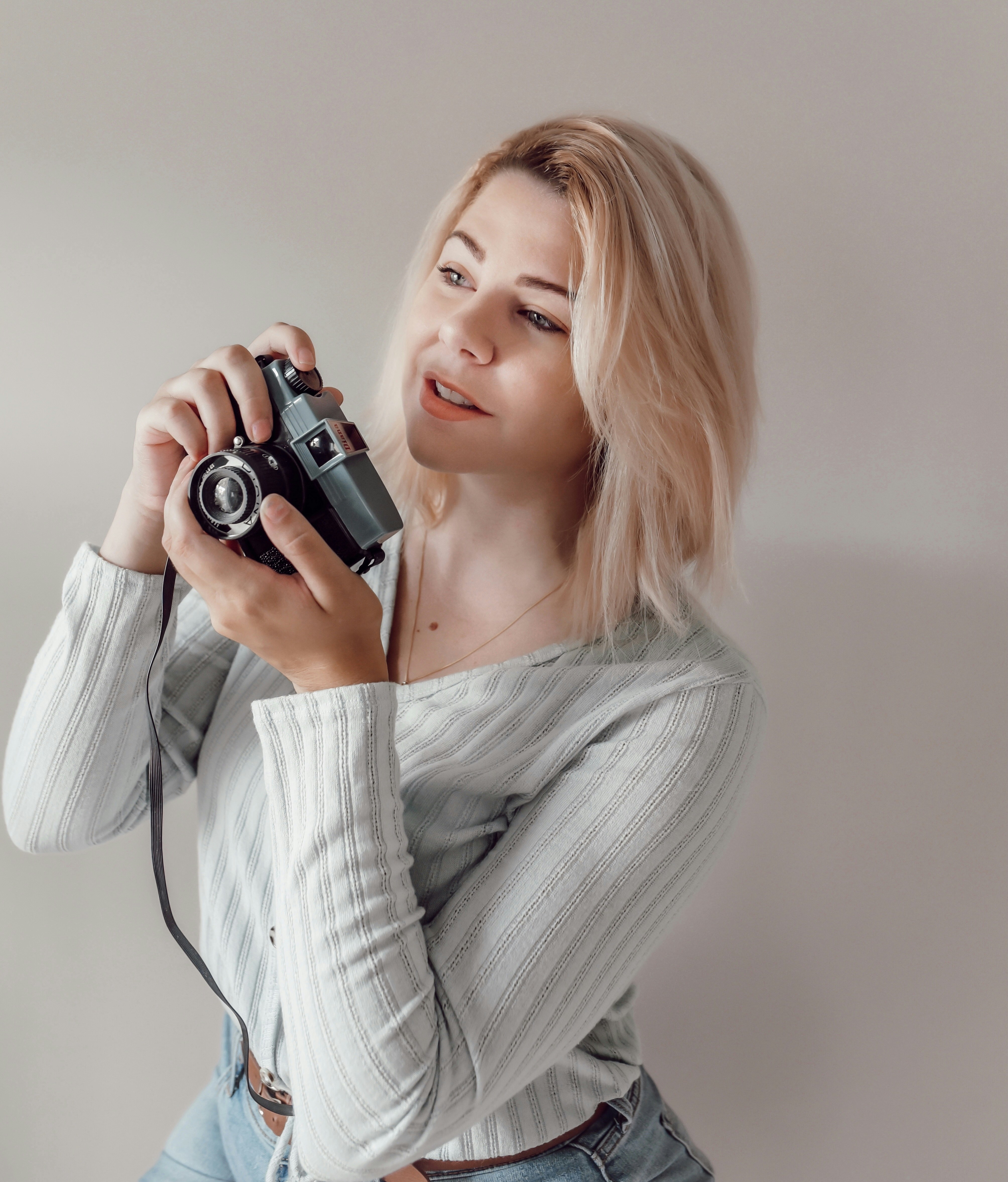 a woman taking a picture with a camera
