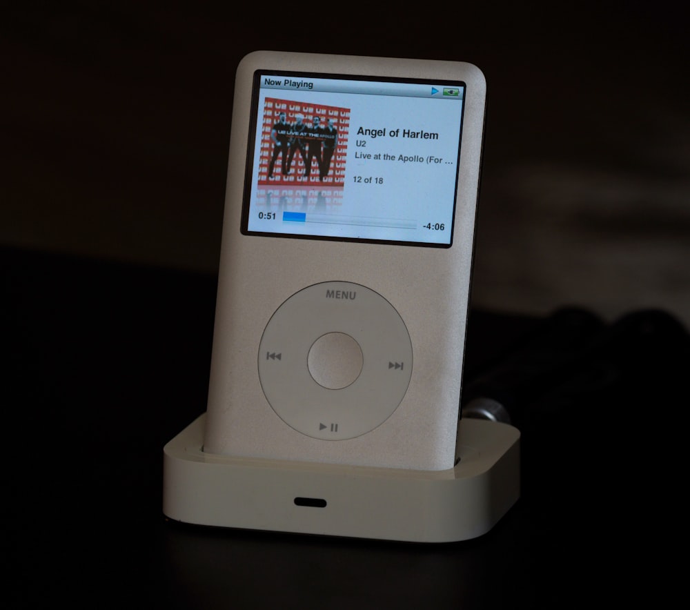 a white ipod sitting on top of a table