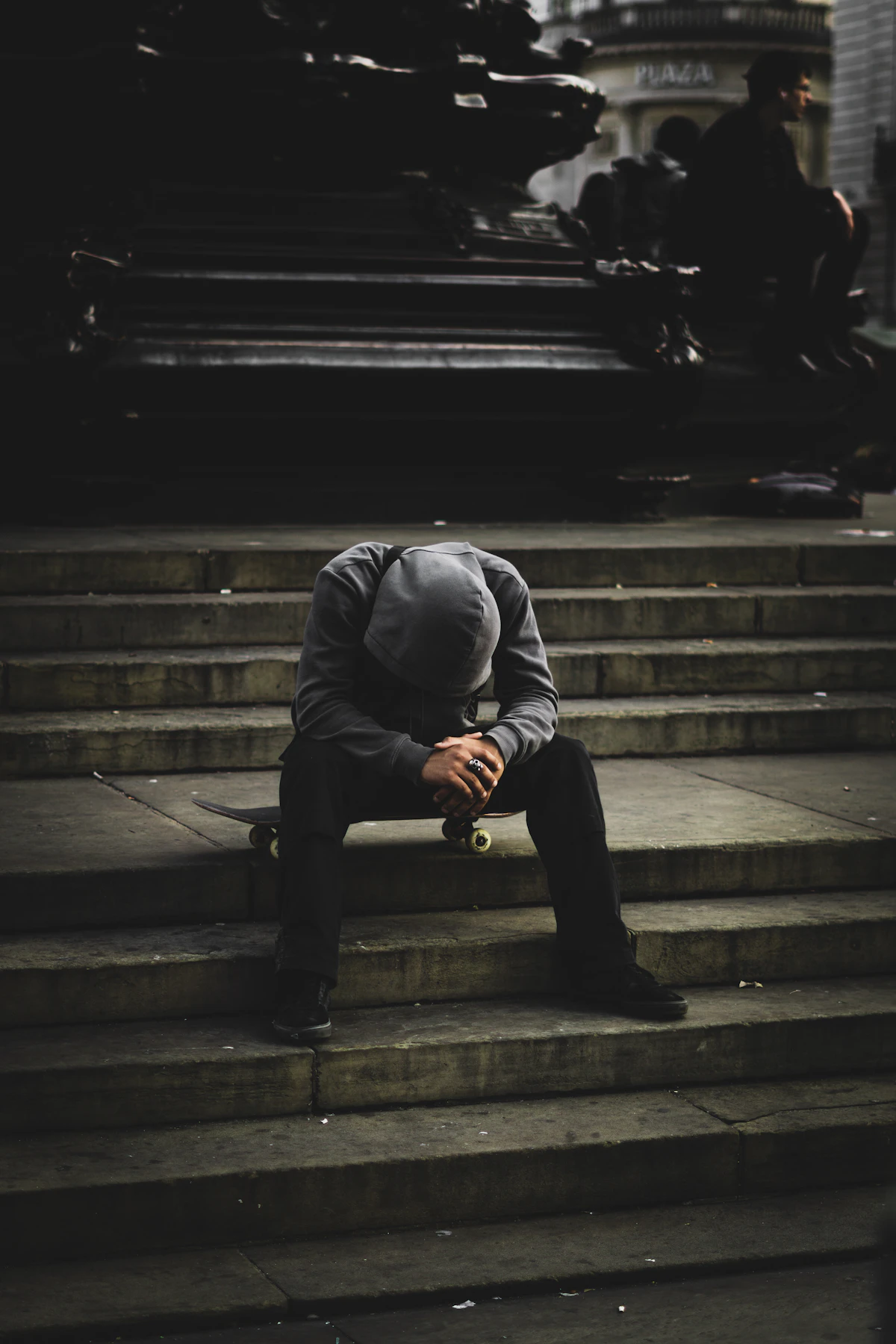 A person sitting with their head in their hands, the private moment behind a competent public face