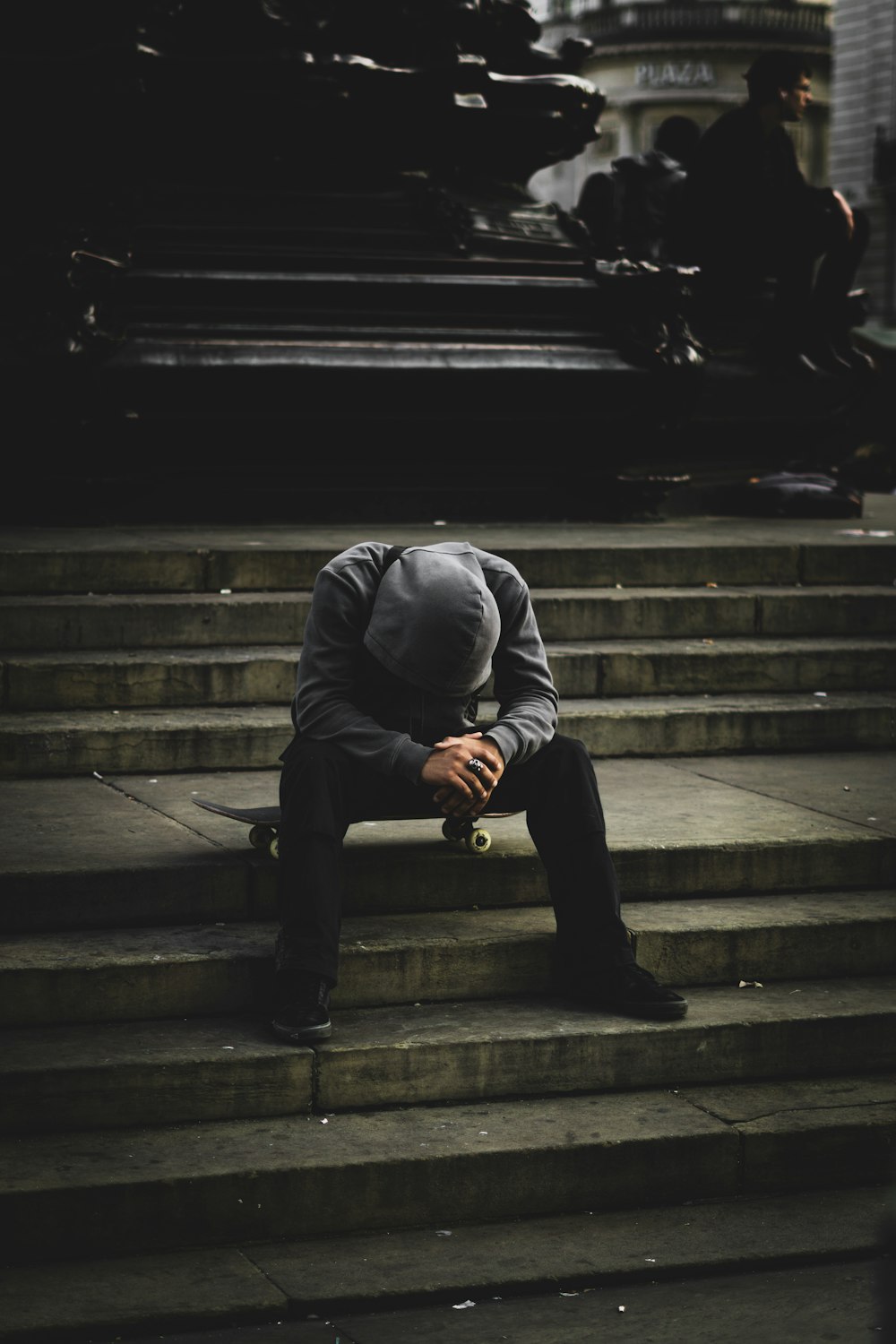 a man sitting on some steps with his head in his hands