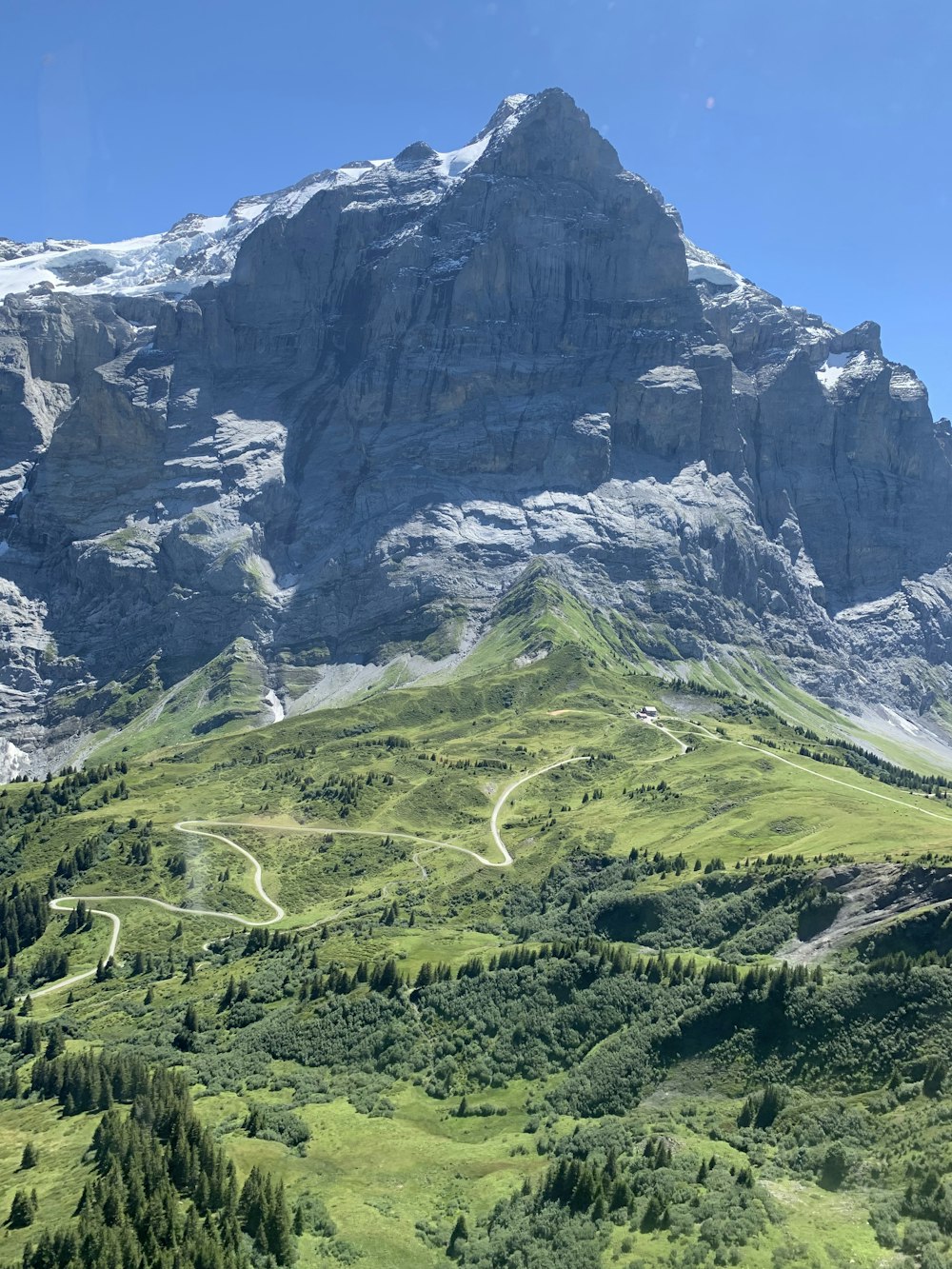 a view of a mountain with a winding road in the foreground