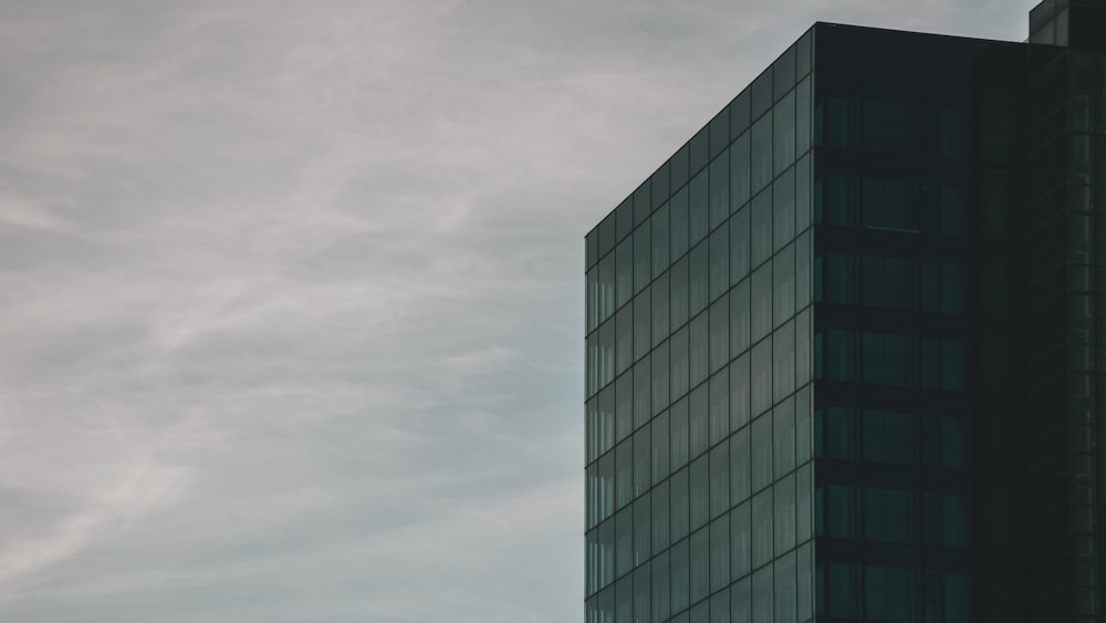 a tall building with a sky in the background