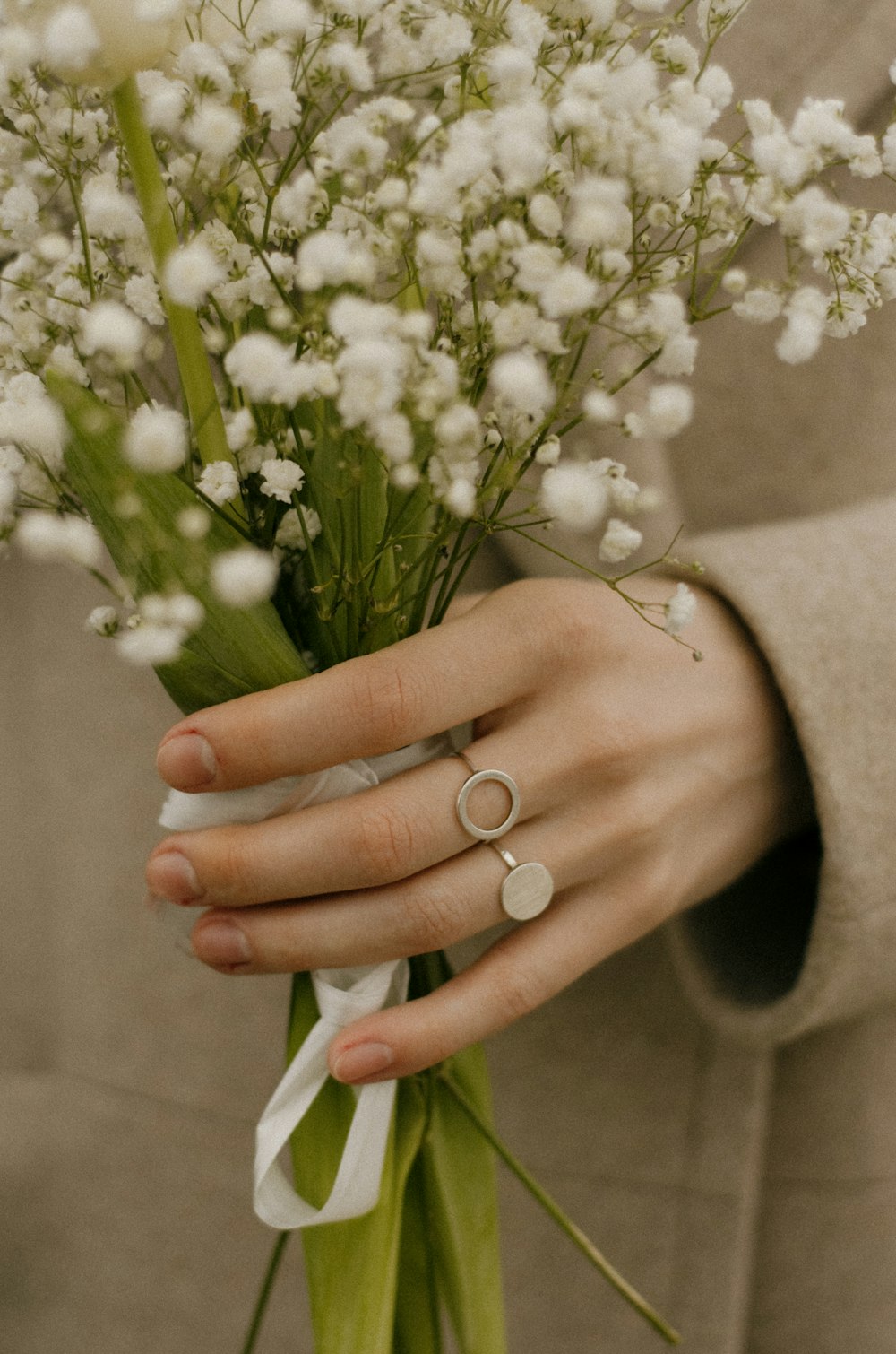 a close up of a person holding a bouquet of flowers