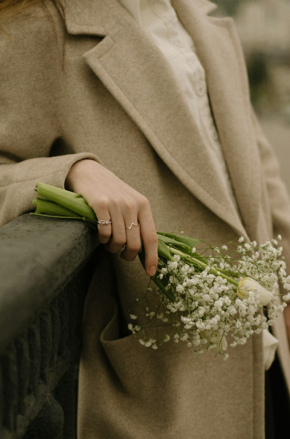 a woman is holding a bouquet of flowers