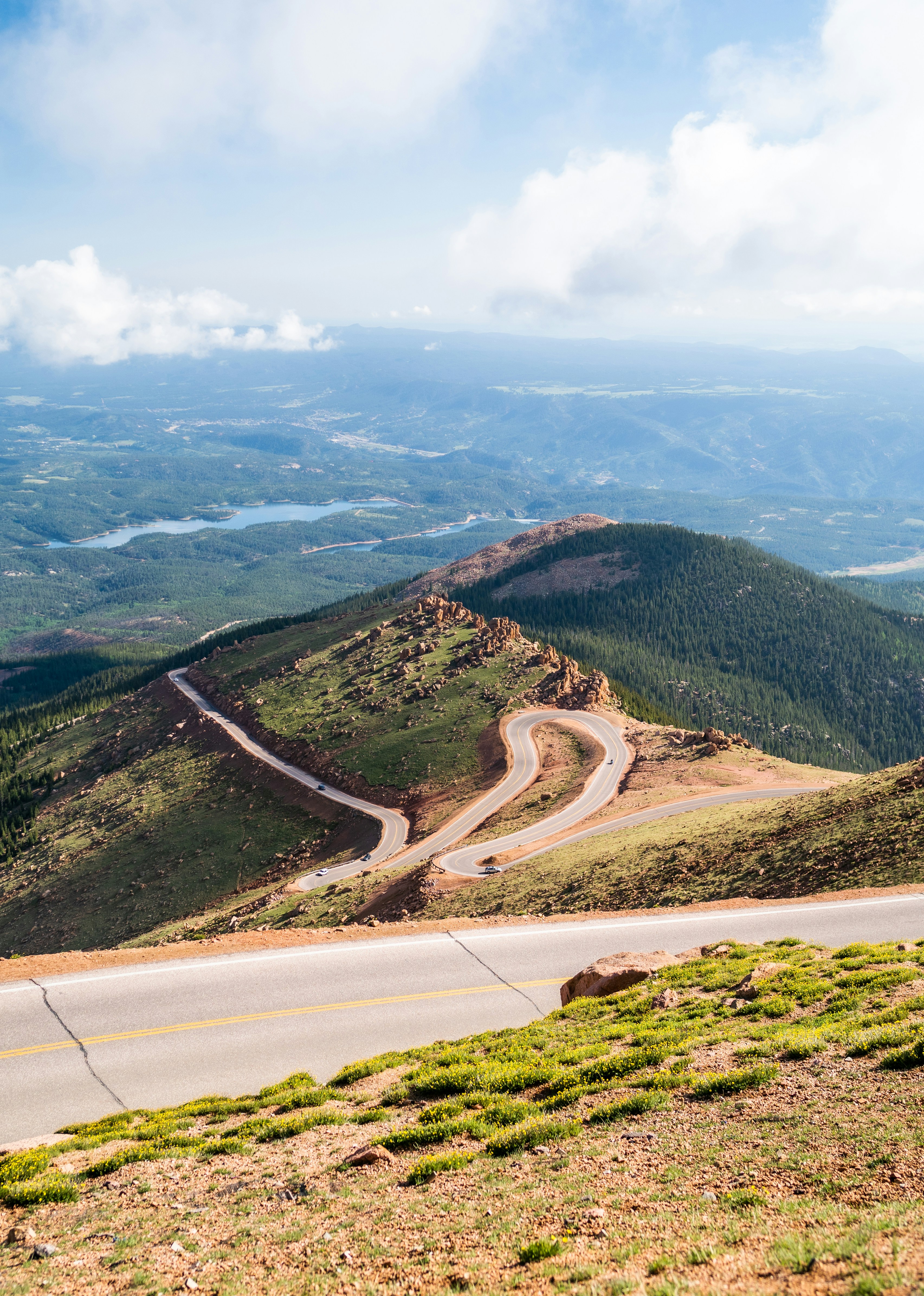 a view of a winding mountain road from the top of a hill
