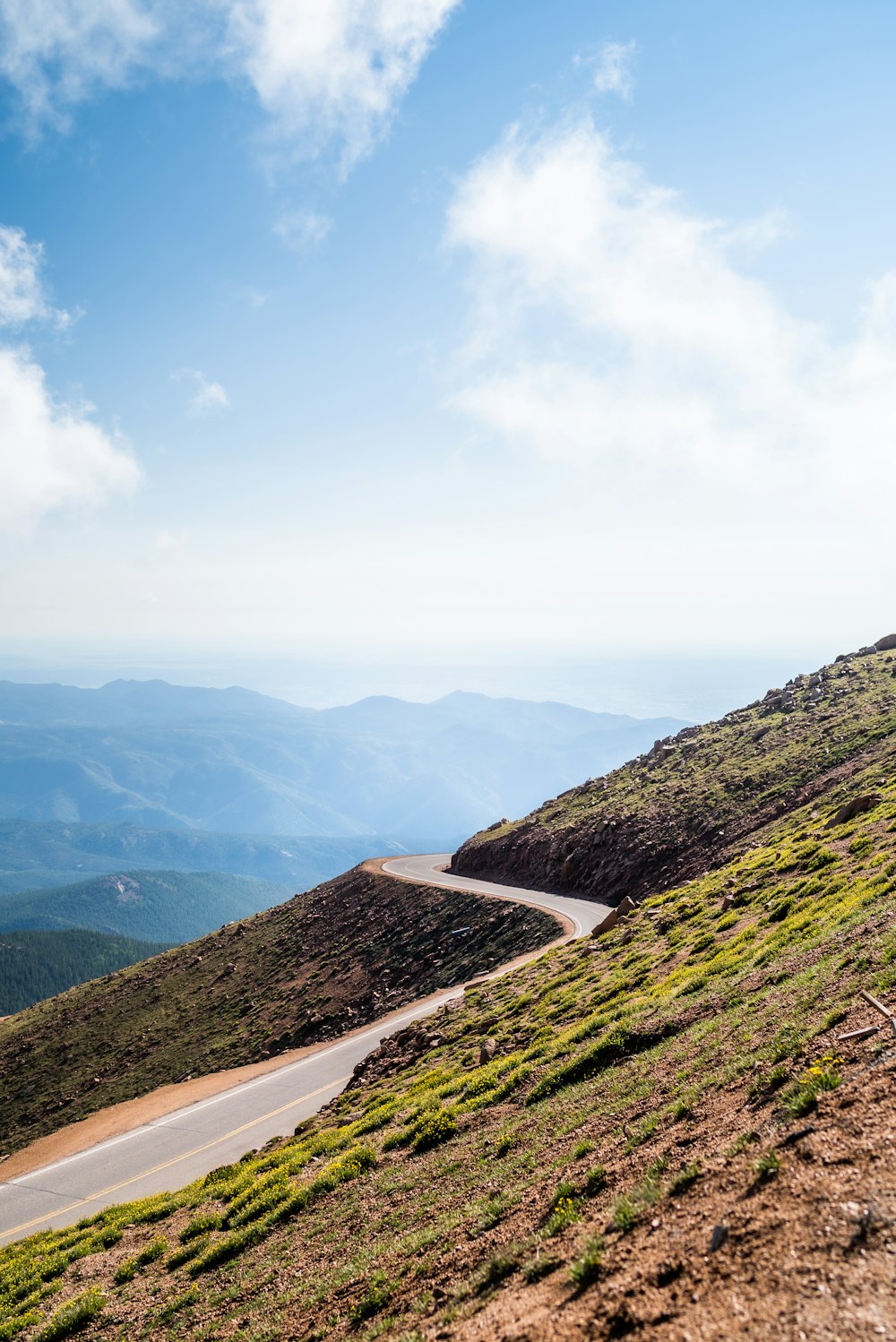 a man riding a bike down a dirt road