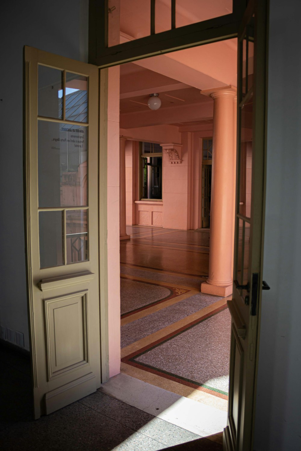 an open door leading into a room with a window