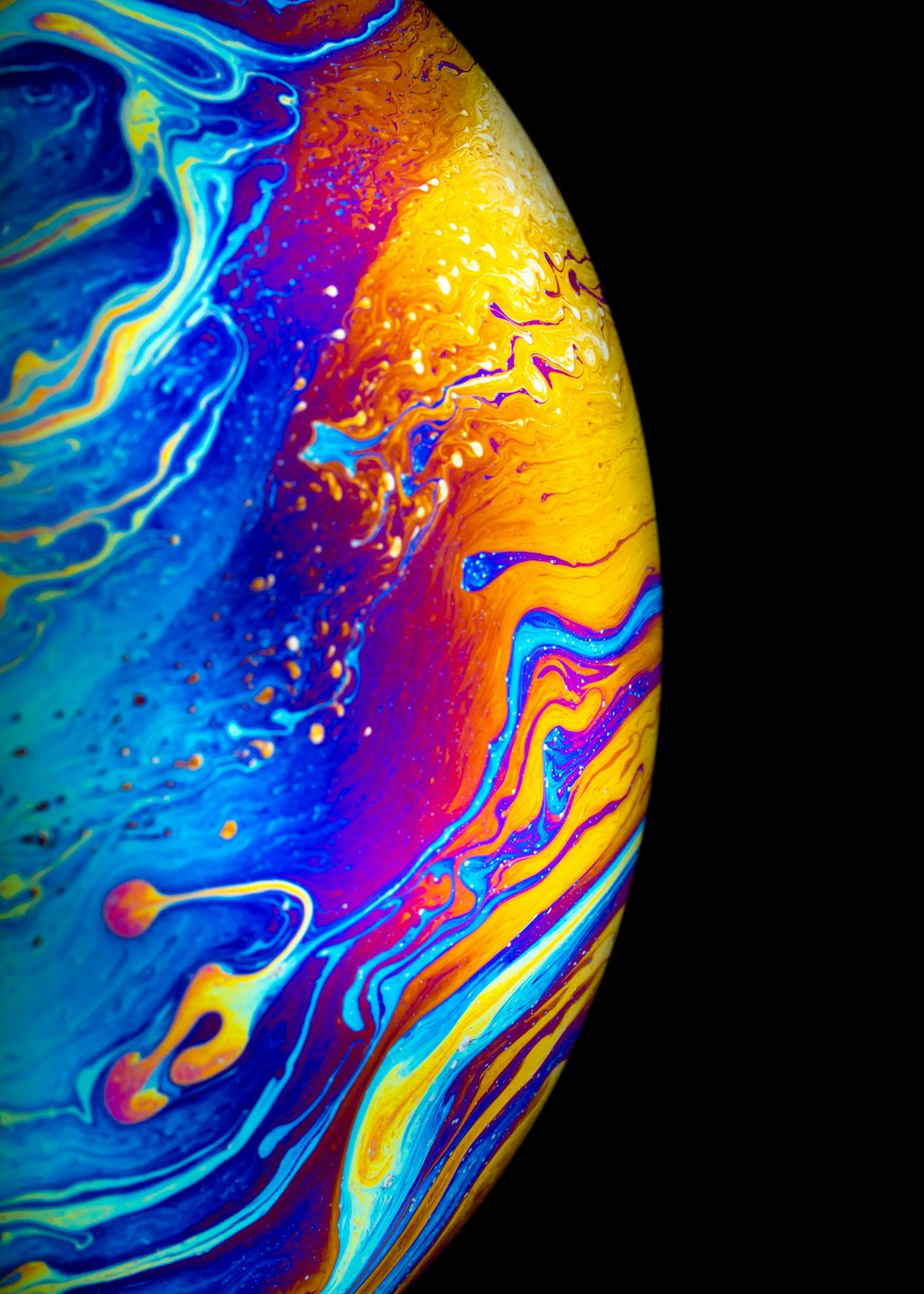 a close up of a colorful object with a black background