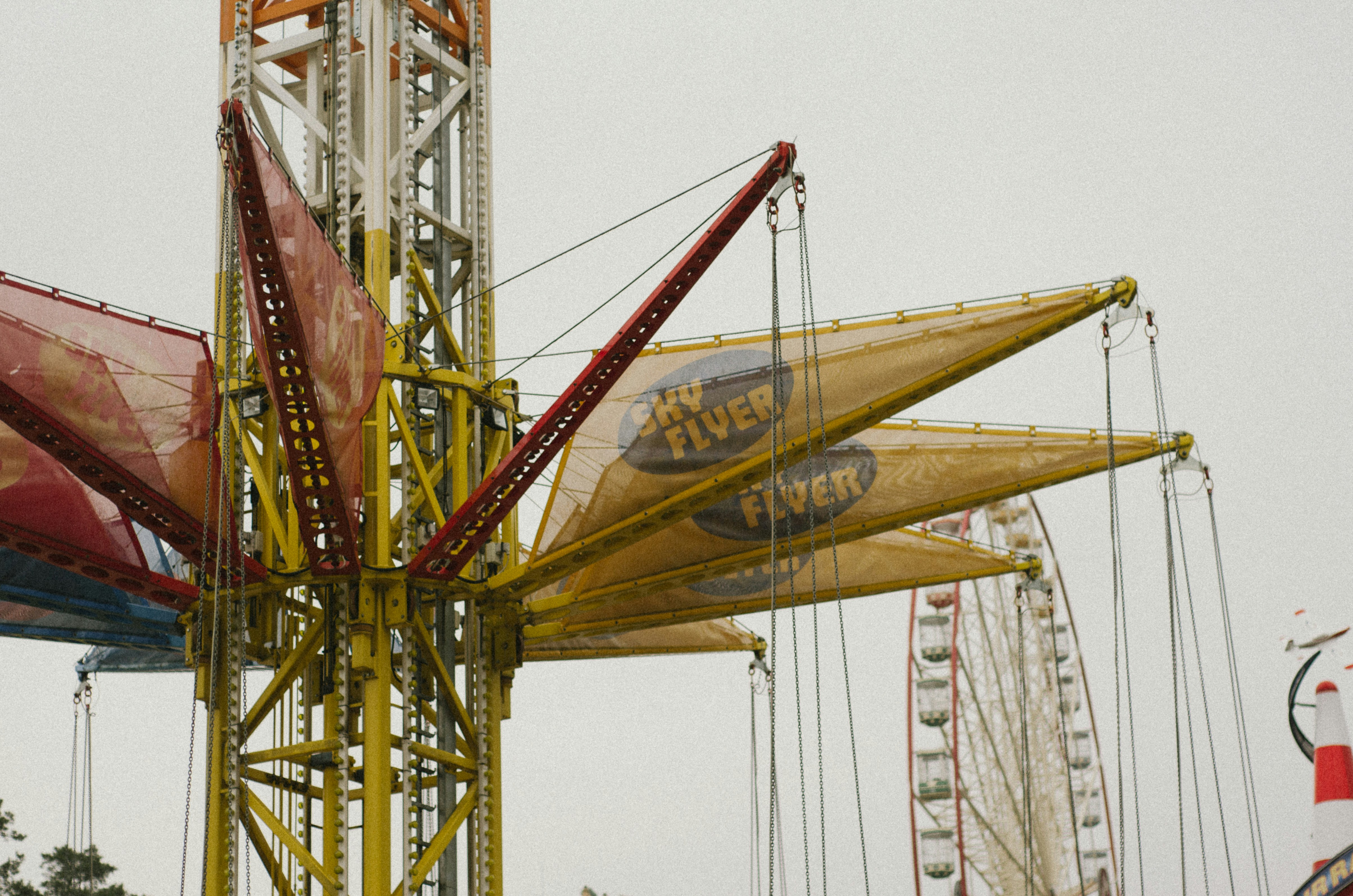 a carnival ride with a ferris wheel in the background