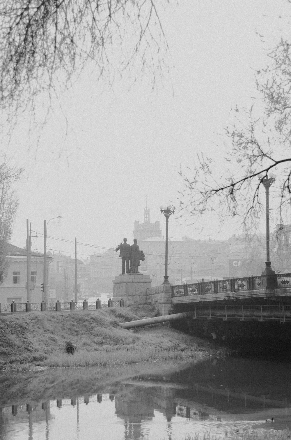 a black and white photo of a bridge over a river