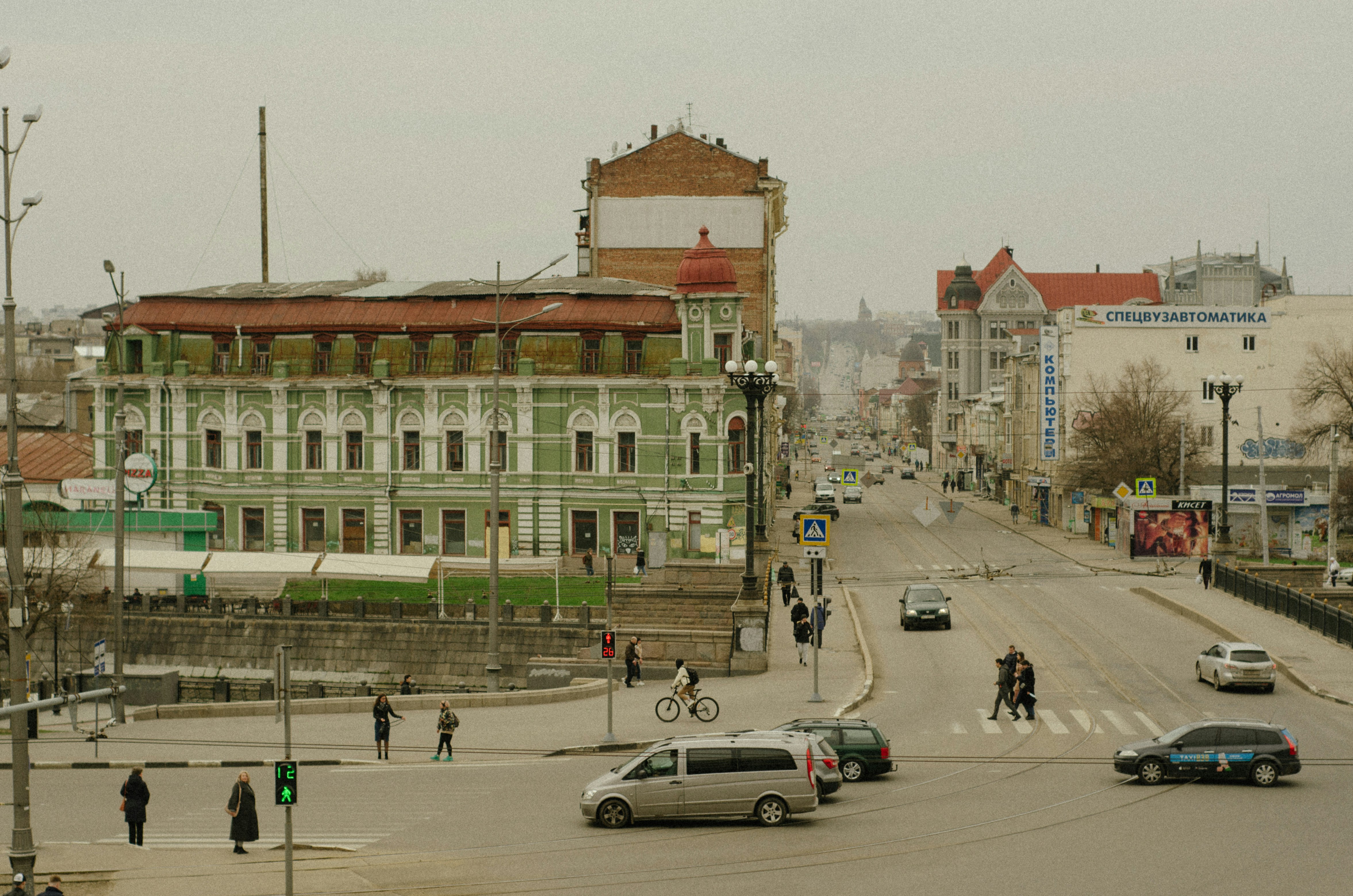 a group of people crossing a street in front of a building