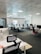 A modern office space with fresh paint, stylish furniture, and well-organized workstations.