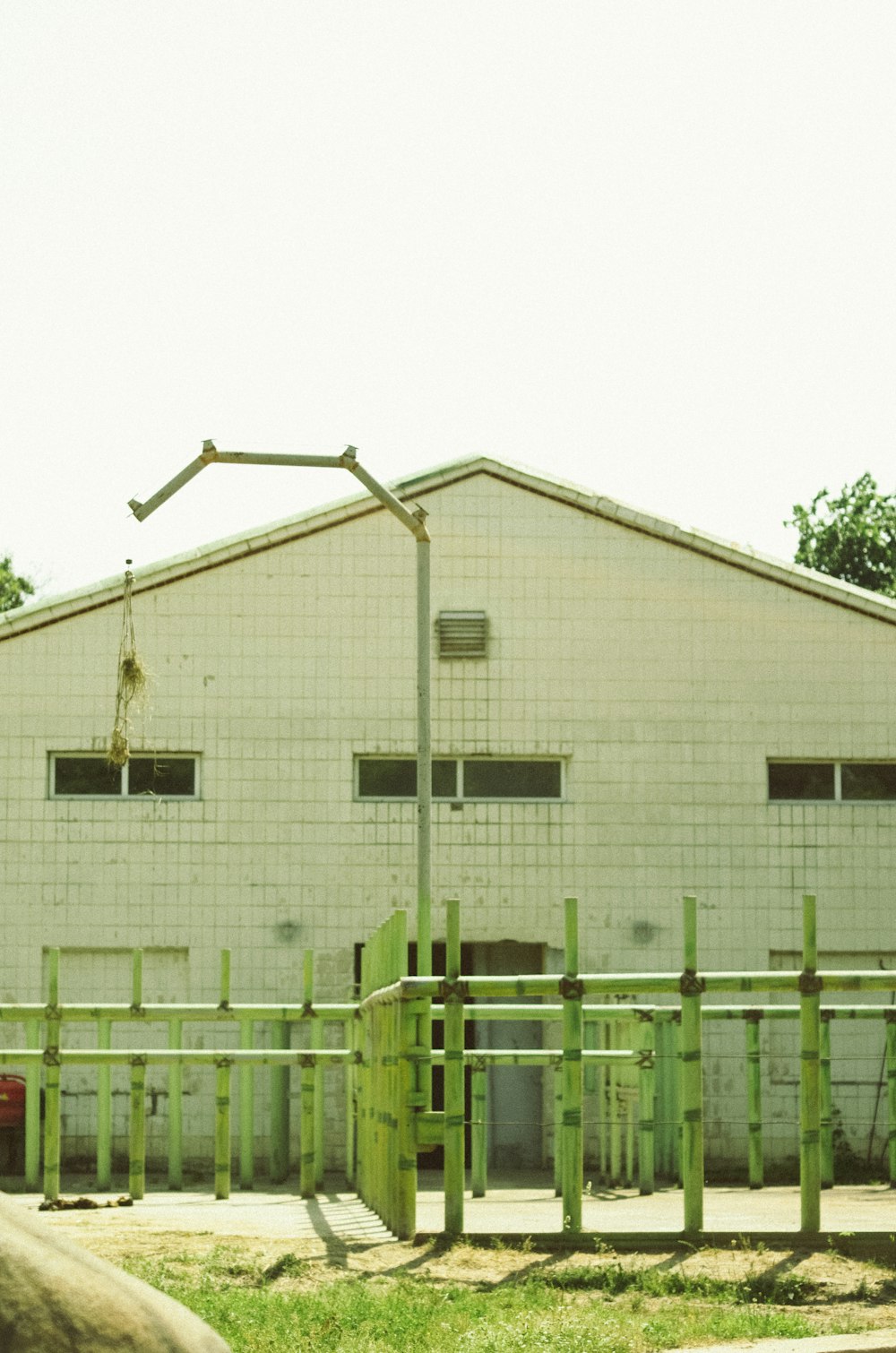 a white building with a green fence around it