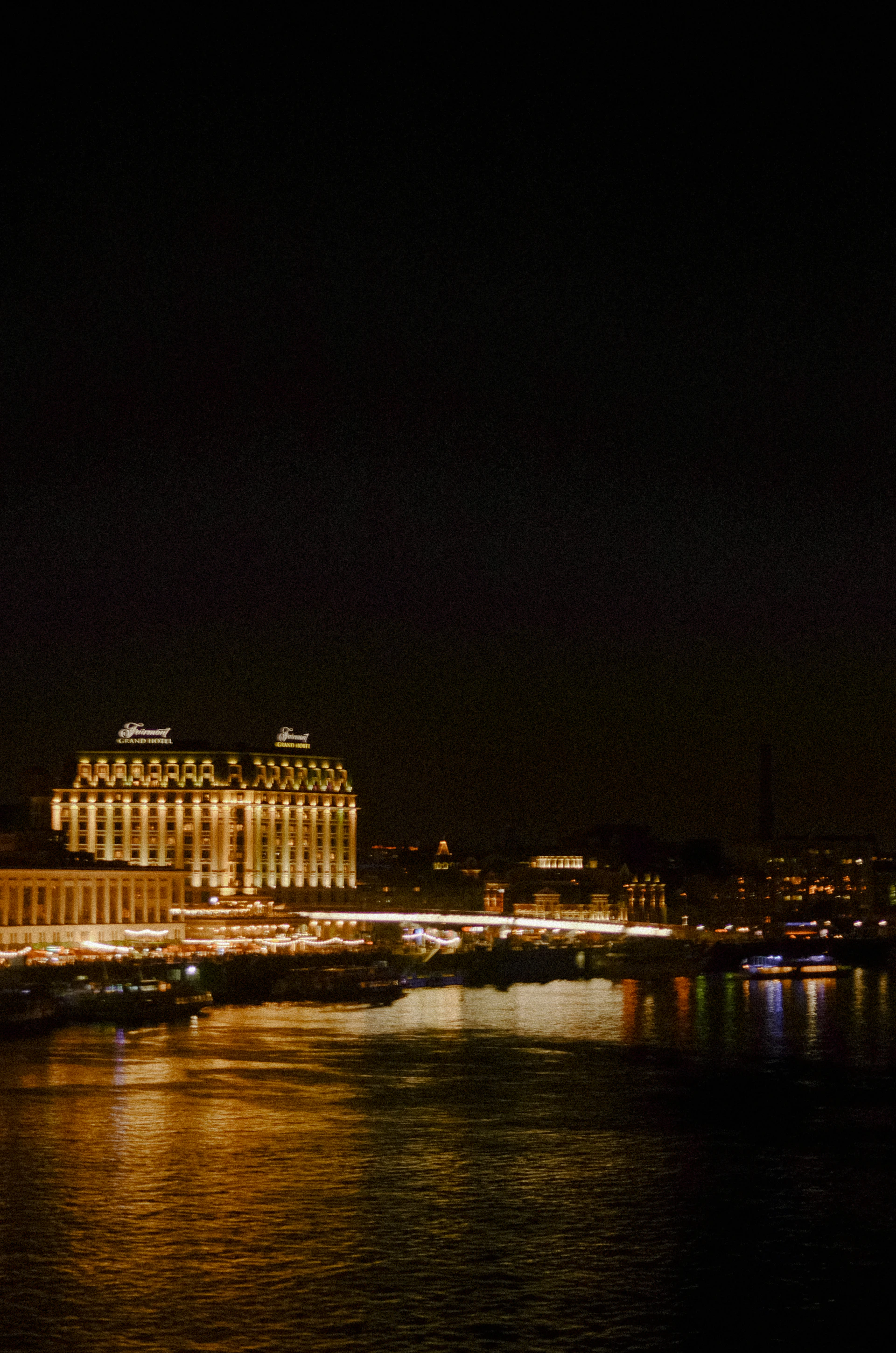 a bridge over a body of water with a city in the background