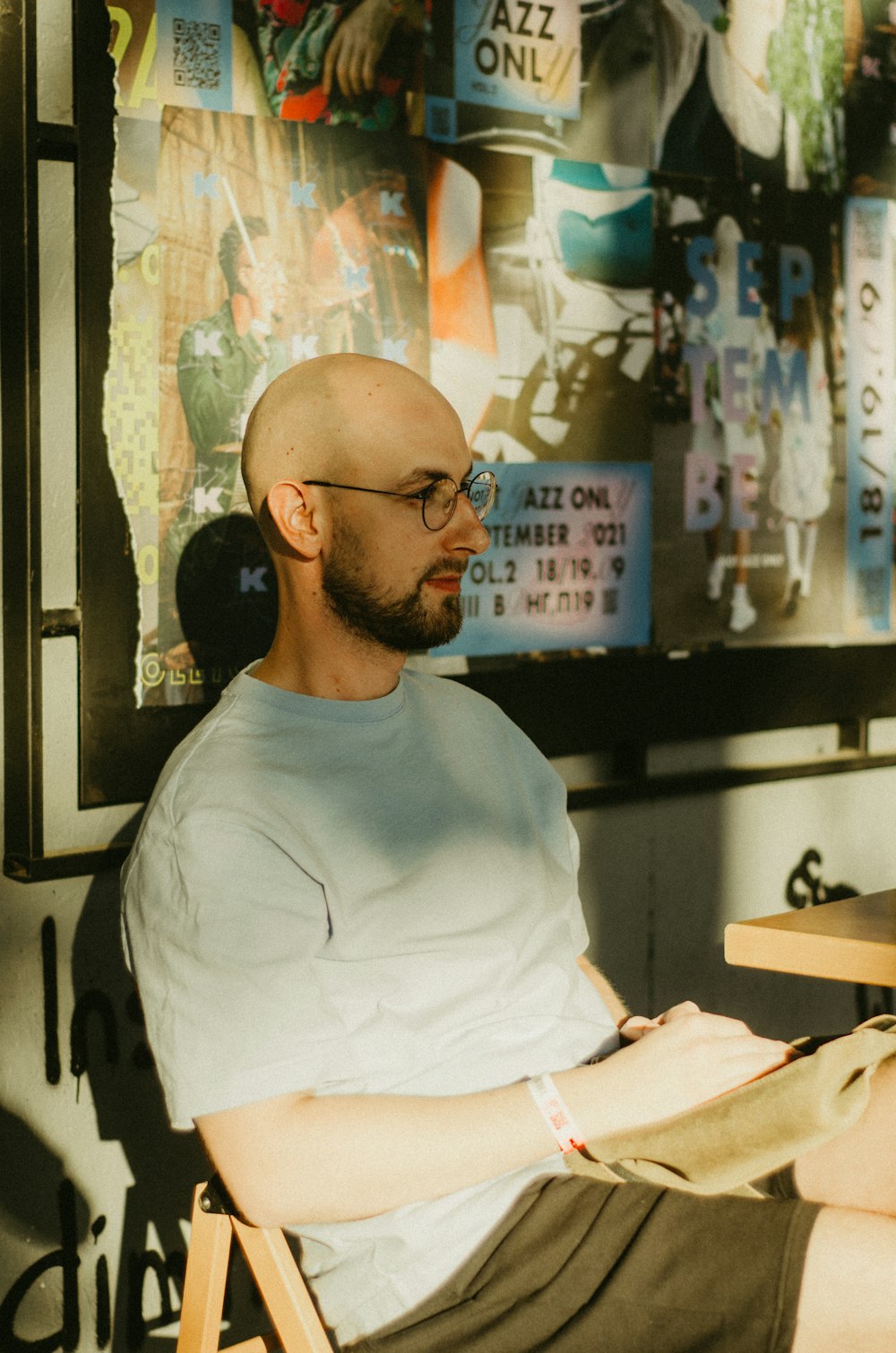 a man with a bald head sitting in a chair