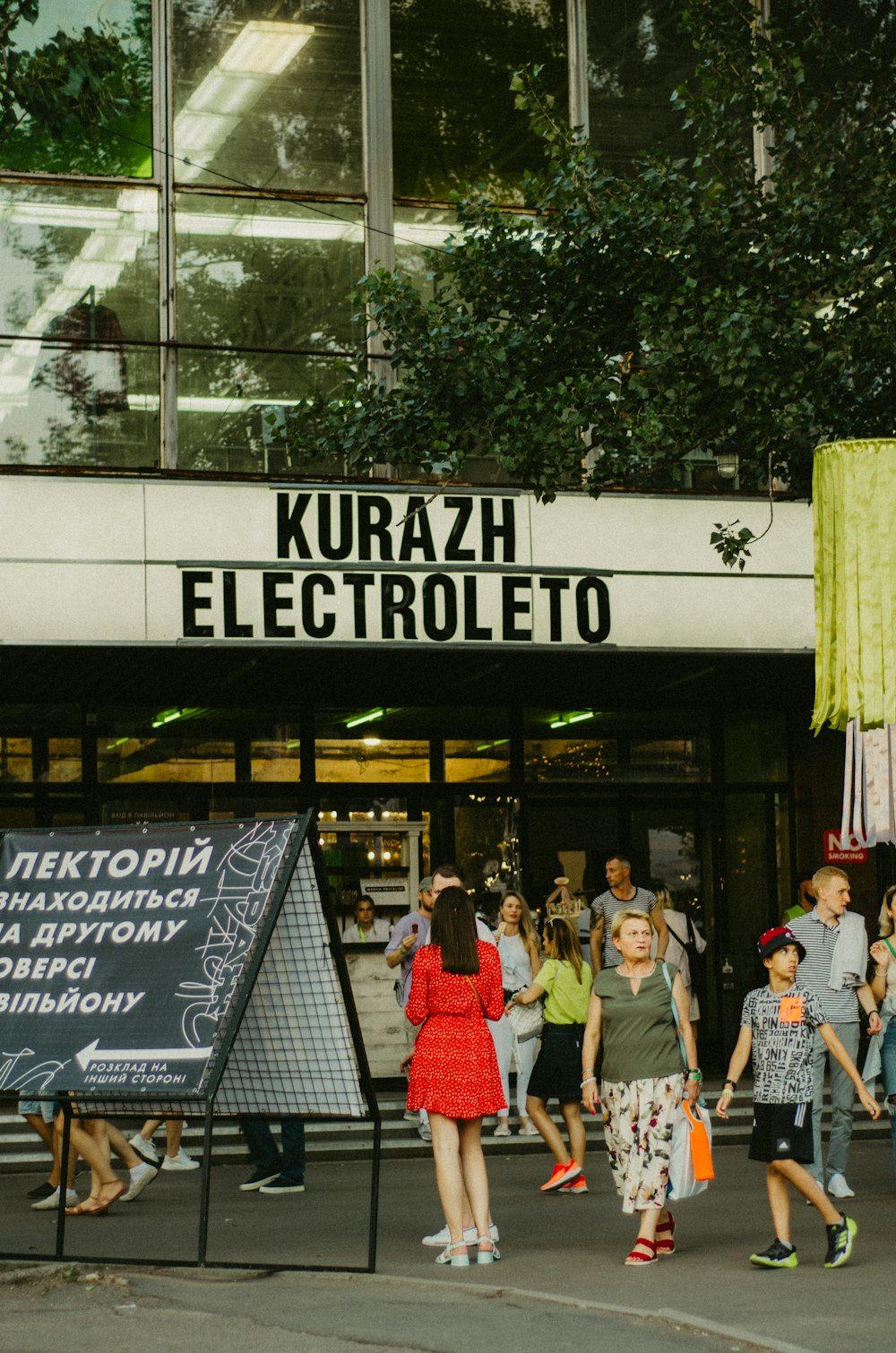 a group of people walking in front of a building