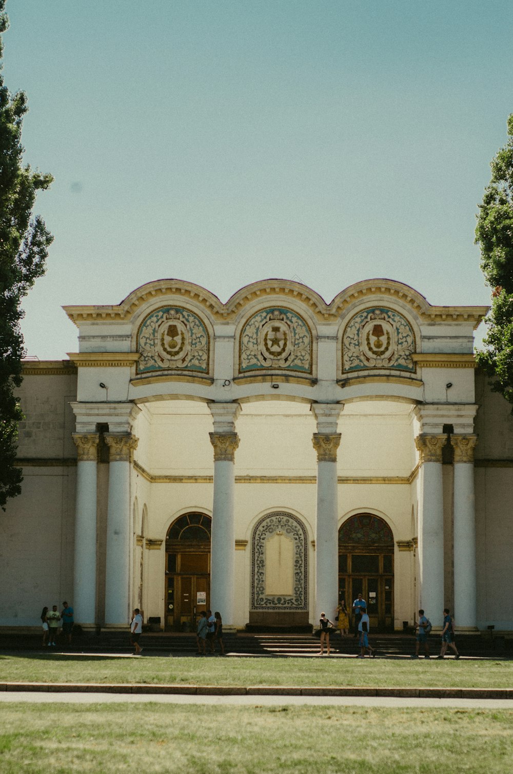 a large white building with a clock on the front of it