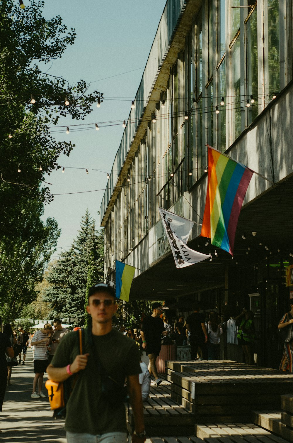 a man walking down a street holding a kite