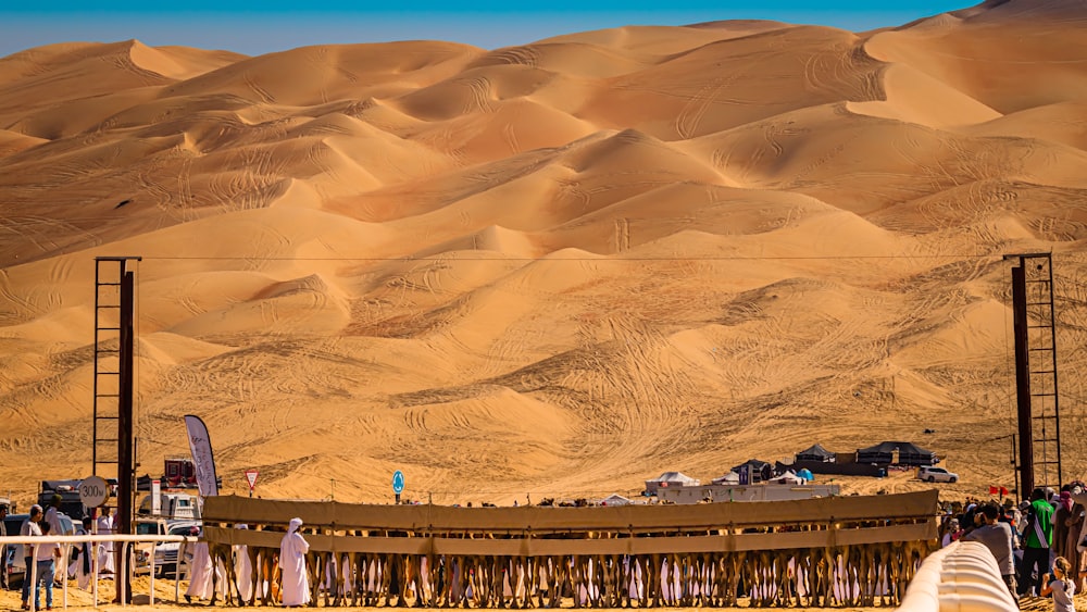 a group of people standing in front of a desert