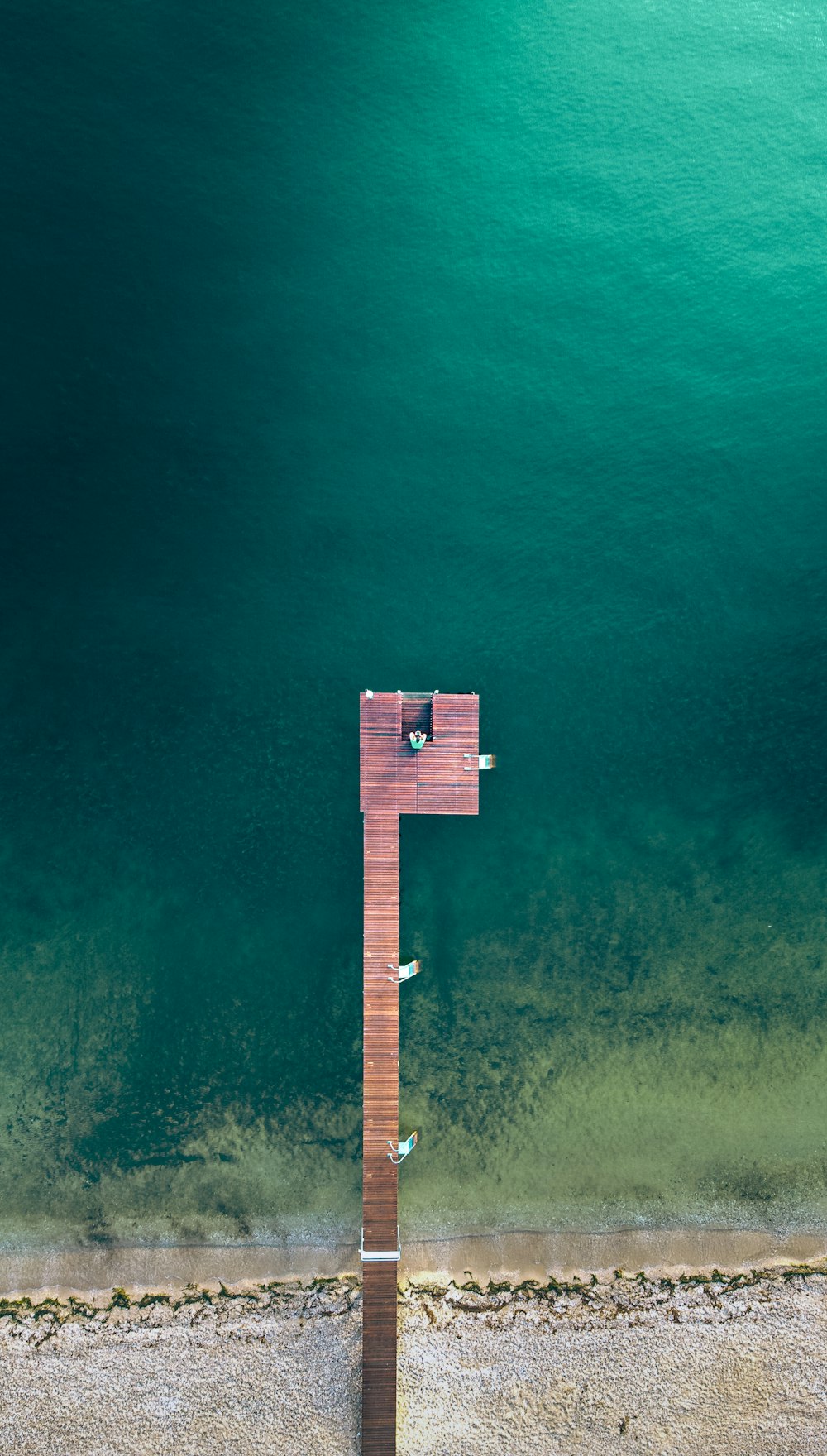 an aerial view of a wooden structure in the water