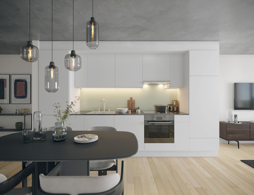 a kitchen with a table, chairs and a television