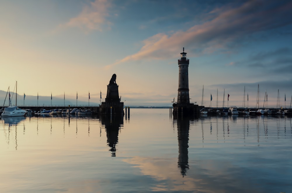 a body of water with a light house in the middle of it