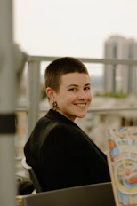 a woman sitting in a chair holding a book