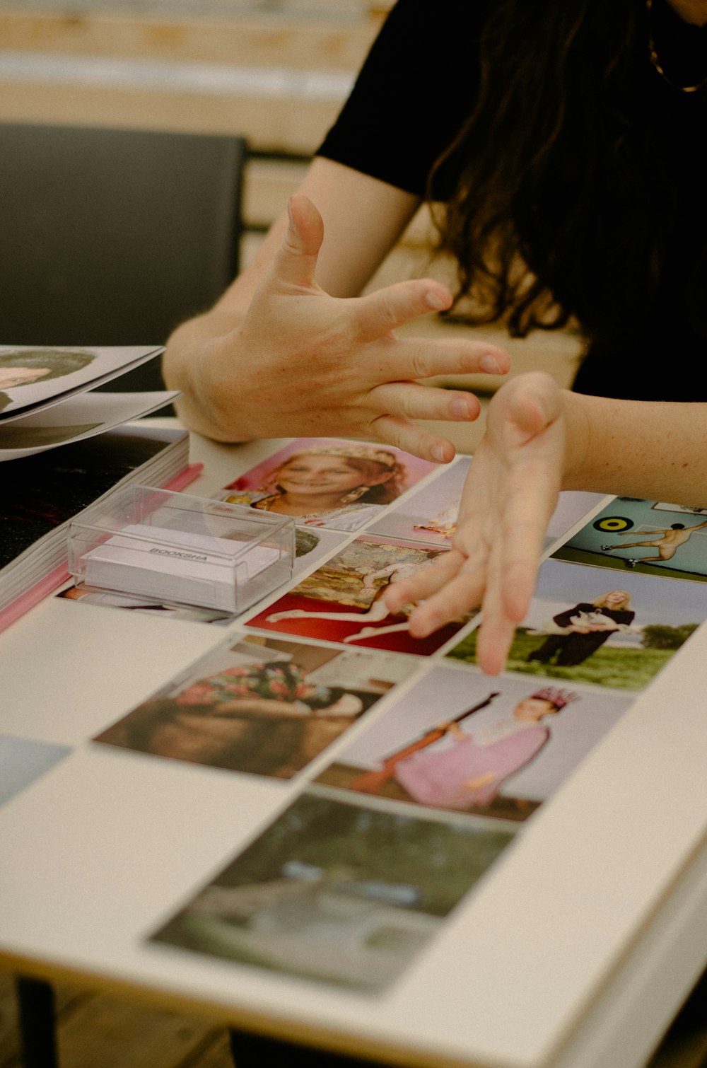 a table topped with pictures of people and hands