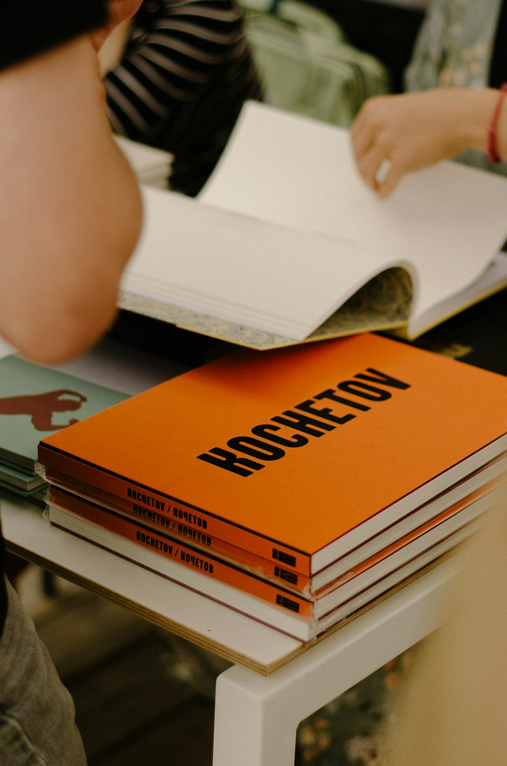 a stack of books sitting on top of a white table