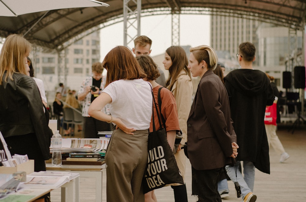 a group of people standing around a table