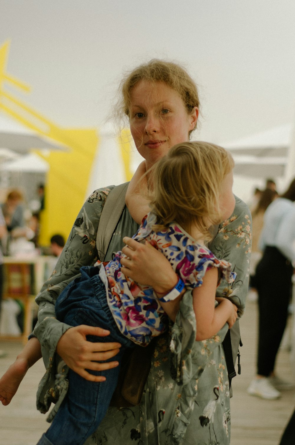 a woman holding a little girl in her arms