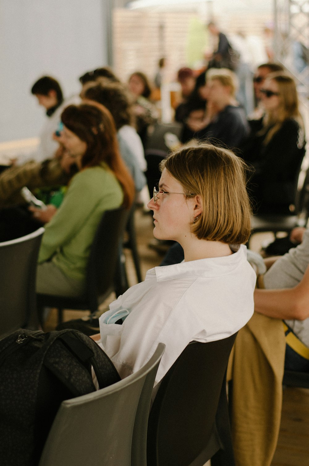 a group of people sitting in chairs in a room