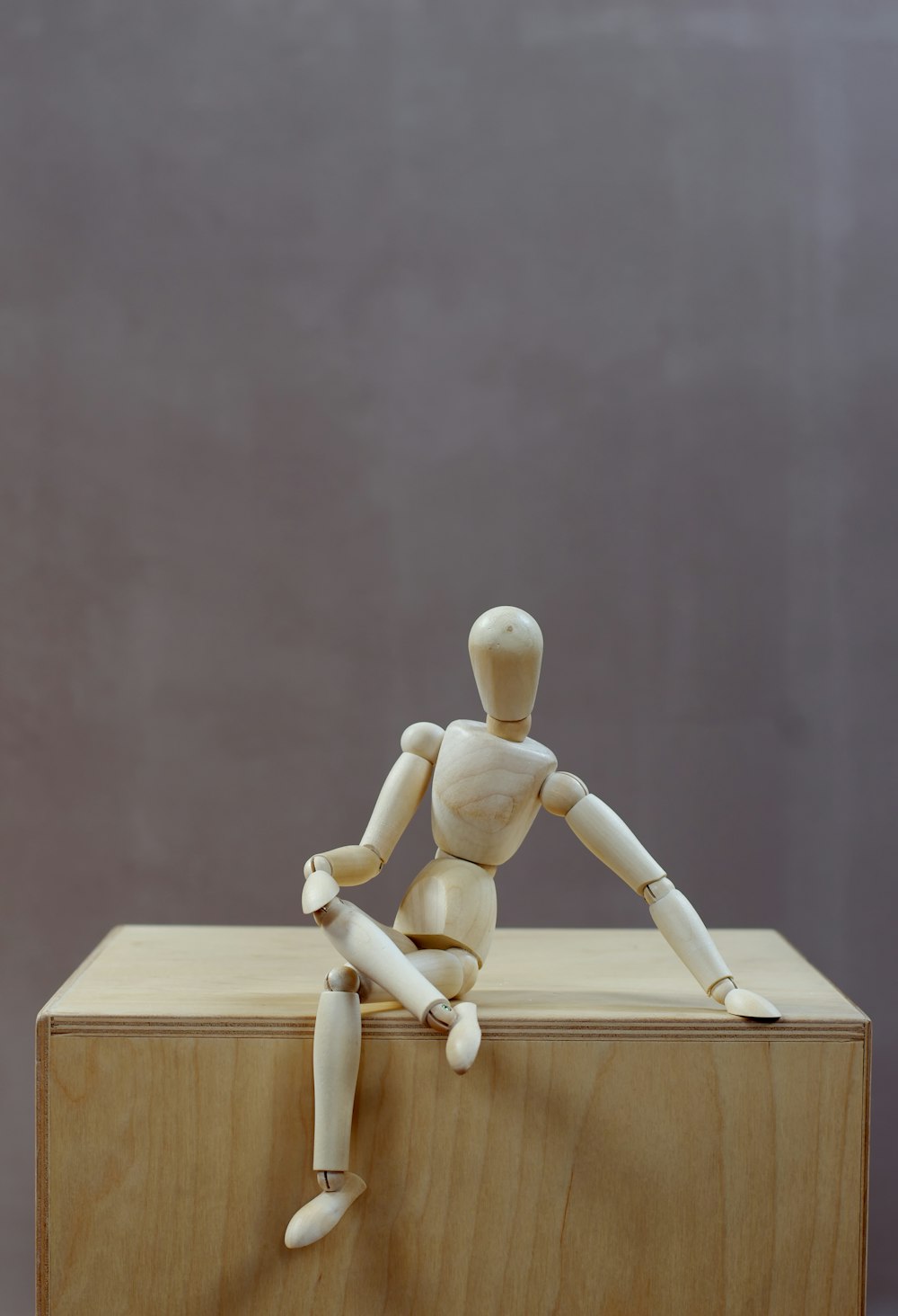 a wooden toy sitting on top of a wooden block