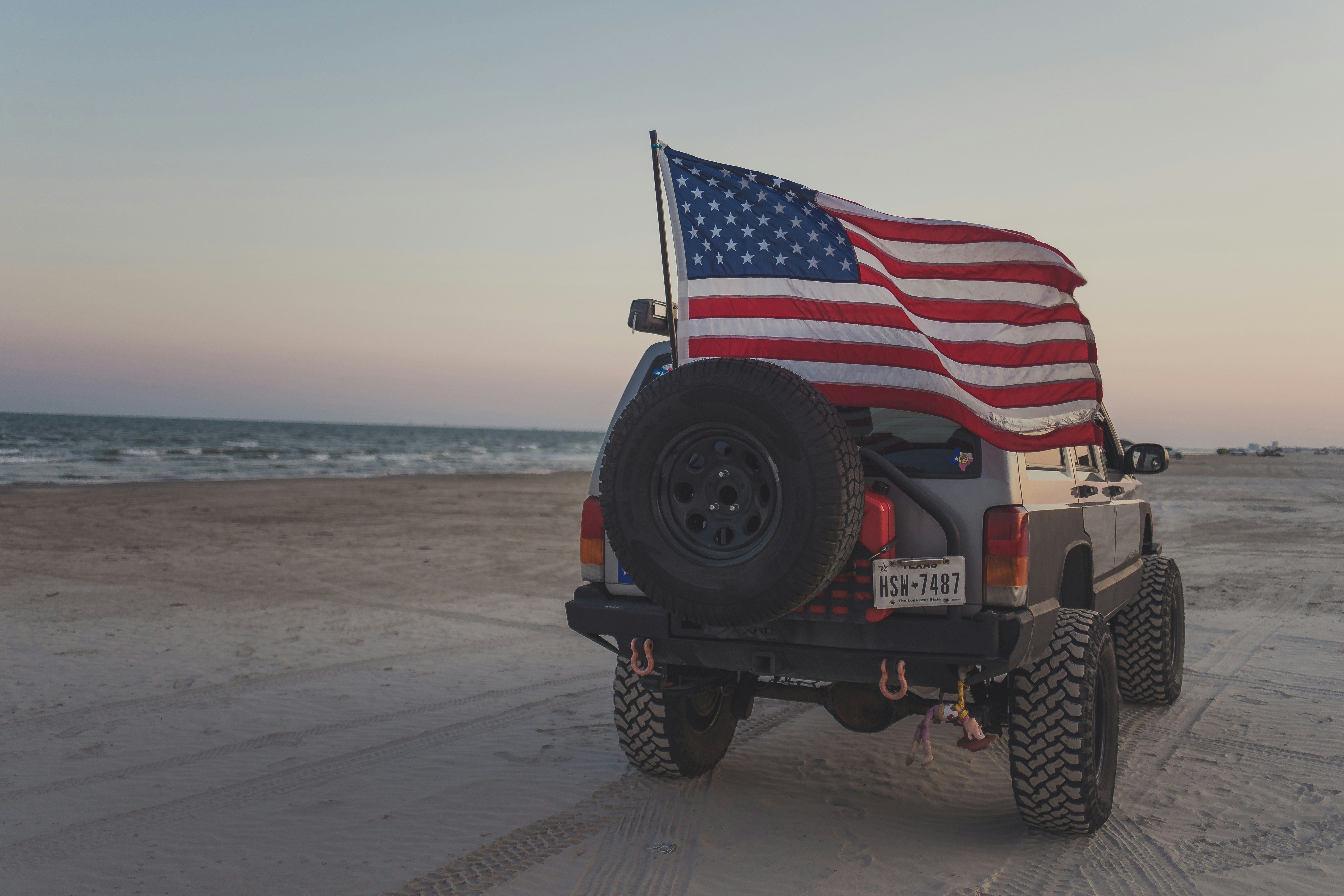 a jeep with an american flag on the back of it