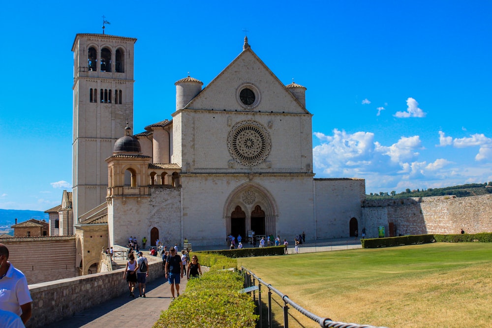 a group of people walking in front of a church