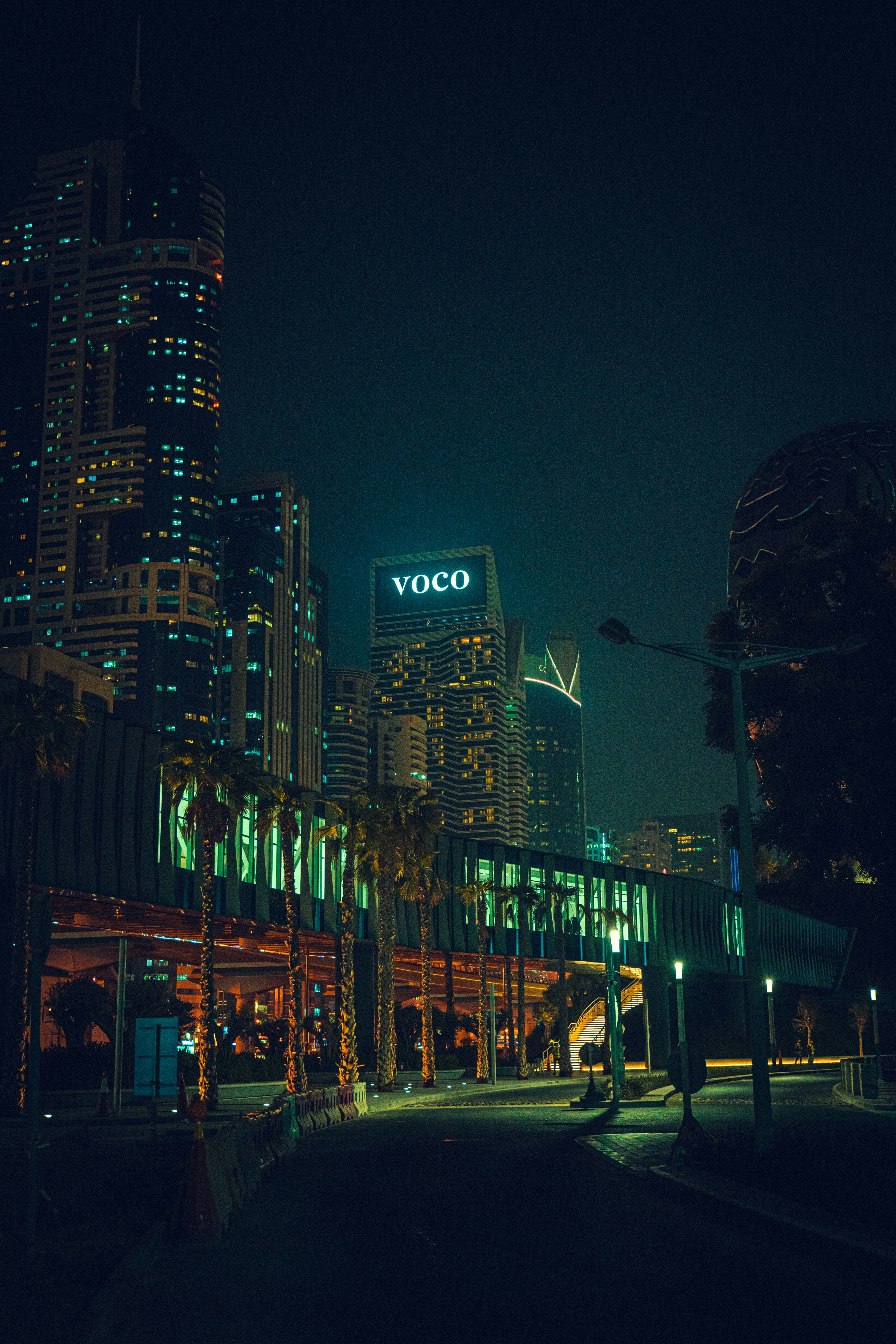 a very tall building with a neon sign on it's side