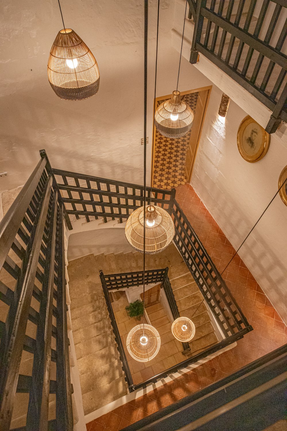 an overhead view of a staircase with chandeliers