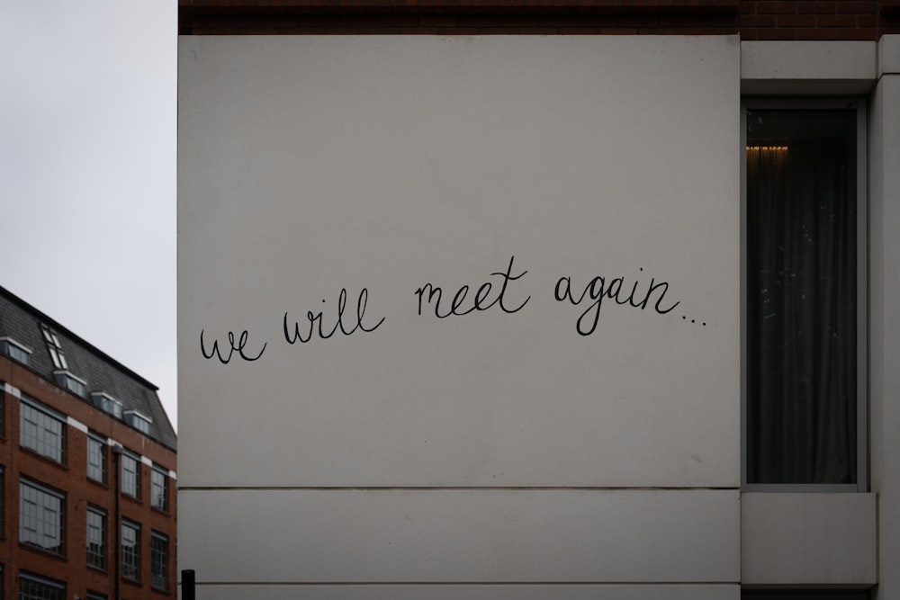 a wall with writing on it that says we will meet again
