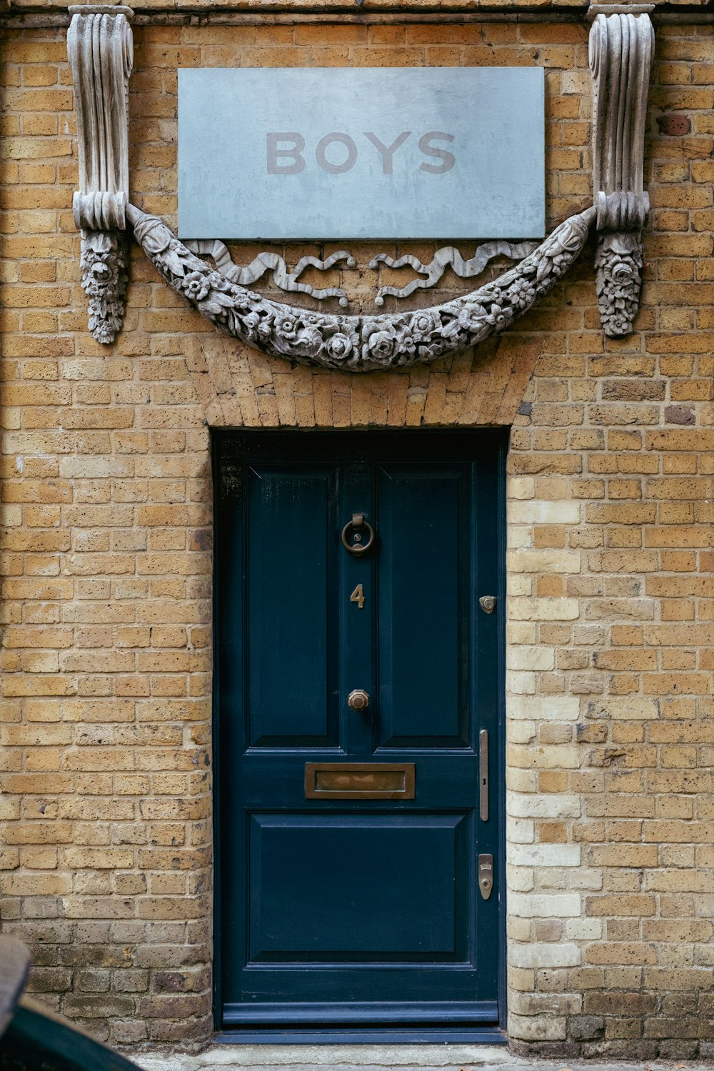 a blue door with a sign above it