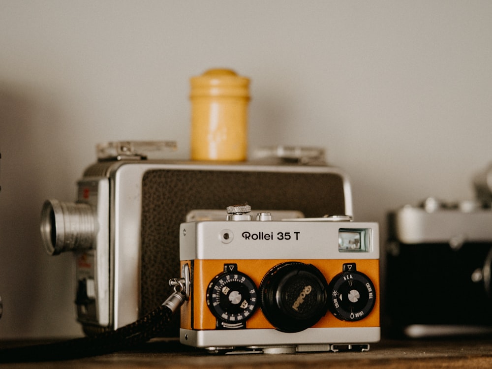 an old camera sitting on top of a wooden table